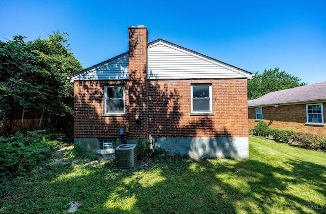 7866 Stillwell Rd, Cincinnati, OH 45237 - view of side of property with a chimney, a yard, and brick siding