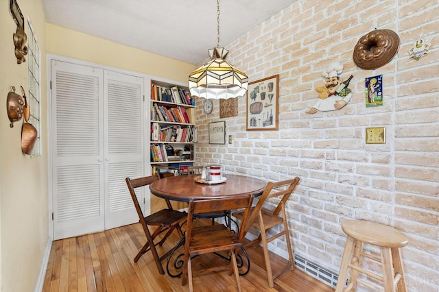 600 Kathryn Dr, Wilmington, OH 45177 - dining area with hardwood / wood-style flooring and brick wall