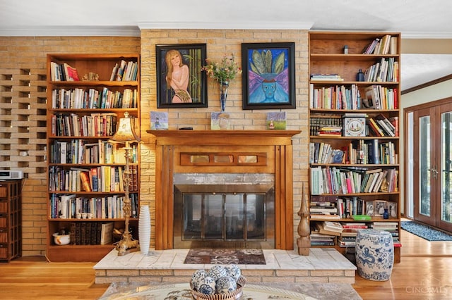 600 Kathryn Dr, Wilmington, OH 45177 - sitting room featuring ornamental molding, a fireplace, wood finished floors, wall of books, and built in shelves