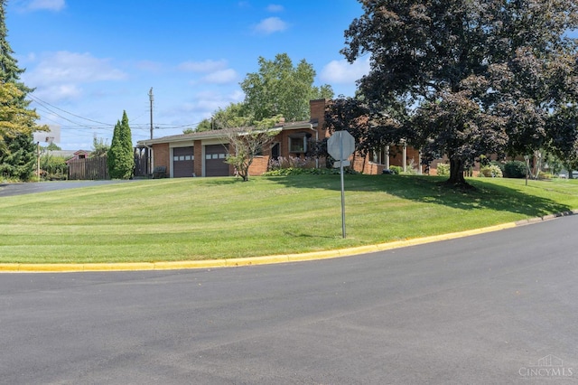 600 Kathryn Dr, Wilmington, OH 45177 - view of front facade with an attached garage, a front lawn, and a chimney