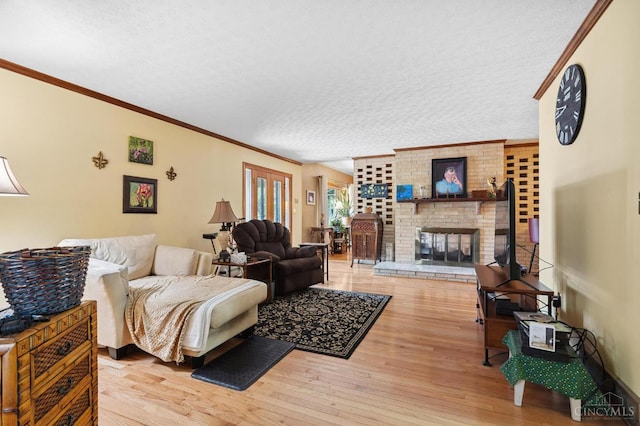 600 Kathryn Dr, Wilmington, OH 45177 - living area featuring wood finished floors, ornamental molding, a textured ceiling, and a fireplace