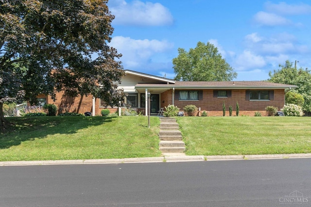 600 Kathryn Dr, Wilmington, OH 45177 - view of front facade featuring a front yard and brick siding