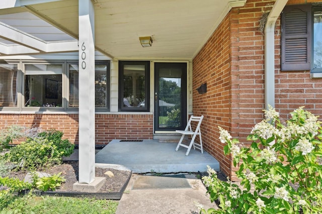 600 Kathryn Dr, Wilmington, OH 45177 - property entrance featuring a porch and brick siding