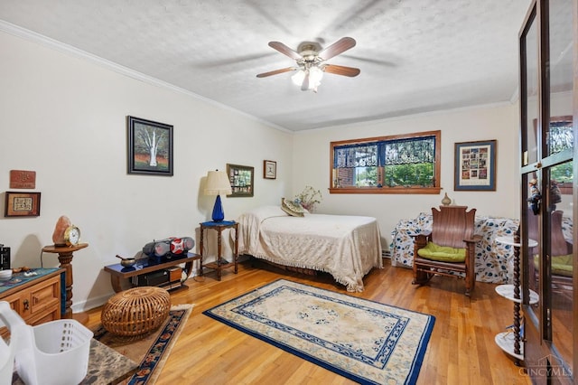 600 Kathryn Dr, Wilmington, OH 45177 - bedroom featuring multiple windows, wood finished floors, a textured ceiling, crown molding, and ceiling fan
