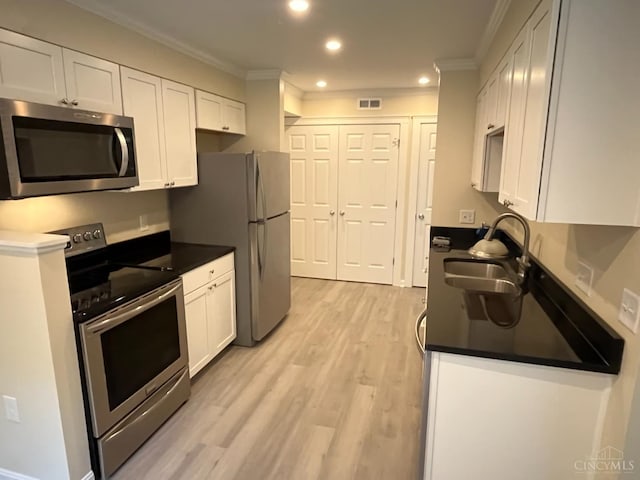 1605 W Augusta Blvd Unit 180, Fairfield, OH 45014 - kitchen with appliances with stainless steel finishes, crown molding, white cabinets, recessed lighting, and dark countertops