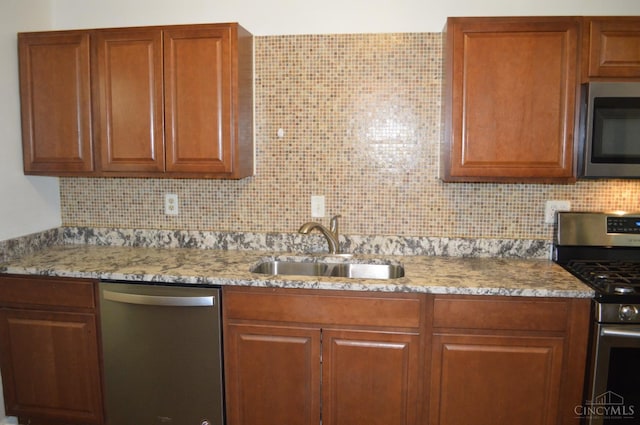11528 Kenn Rd, Forest Park, OH 45240 - kitchen featuring appliances with stainless steel finishes, tasteful backsplash, light stone counters, and brown cabinetry