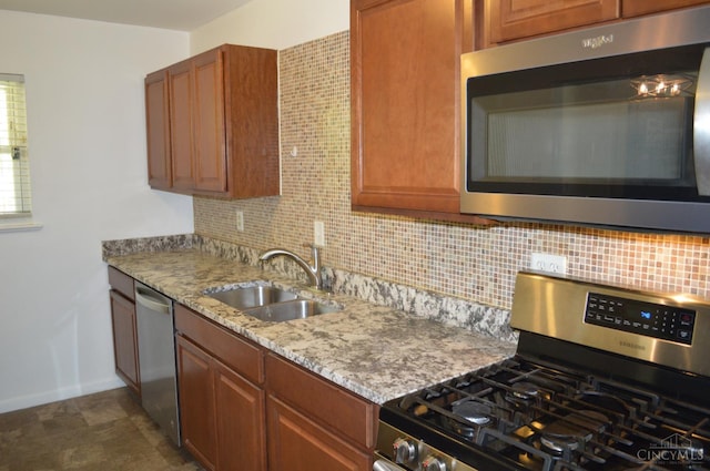 11528 Kenn Rd, Forest Park, OH 45240 - kitchen with appliances with stainless steel finishes, backsplash, light stone countertops, and brown cabinetry