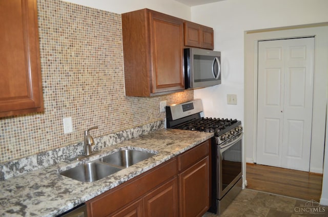 11528 Kenn Rd, Forest Park, OH 45240 - kitchen with stainless steel appliances, tasteful backsplash, light stone countertops, and brown cabinets