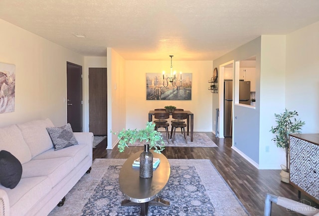 541 Davis Rd Unit 8, Pierce Twp, OH 45255 - living area with a chandelier, dark wood finished floors, and a textured ceiling