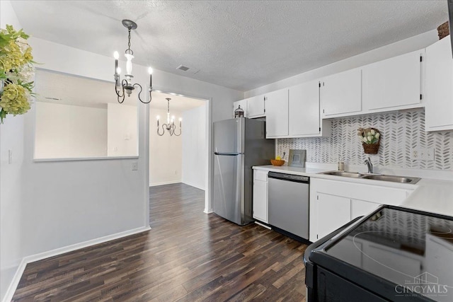 541 Davis Rd Unit 8, Pierce Twp, OH 45255 - kitchen featuring stainless steel appliances, a chandelier, dark wood finished floors, light countertops, and a textured ceiling