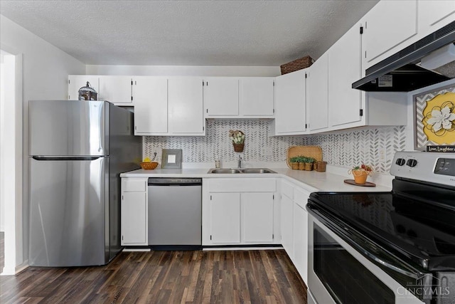 541 Davis Rd Unit 8, Pierce Twp, OH 45255 - kitchen featuring stainless steel appliances, exhaust hood, light countertops, dark wood-style floors, and a textured ceiling