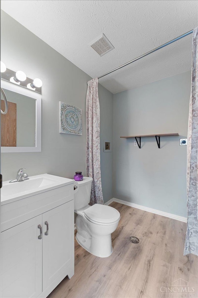 541 Davis Rd Unit 8, Pierce Twp, OH 45255 - bathroom featuring wood finished floors, vanity, and a textured ceiling