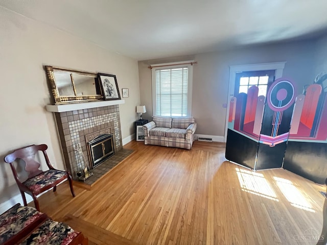 2464 Fairview Ave, Cincinnati, OH 45219 - living area with wood finished floors and a tiled fireplace