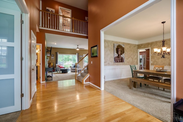 5088 Harvestdale Dr, Mason, OH 45040 - foyer entrance with stairs, wood finished floors, a chandelier, crown molding, and wainscoting