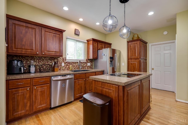 5088 Harvestdale Dr, Mason, OH 45040 - kitchen featuring stainless steel appliances, light wood-type flooring, decorative backsplash, a kitchen island, and decorative light fixtures