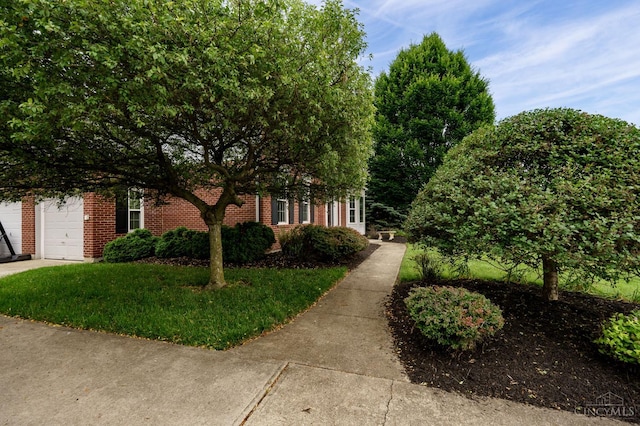 5088 Harvestdale Dr, Mason, OH 45040 - view of front facade with brick siding, driveway, an attached garage, and a front lawn