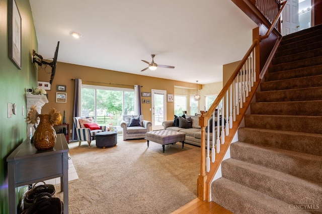 5088 Harvestdale Dr, Mason, OH 45040 - carpeted living room featuring stairway and ceiling fan