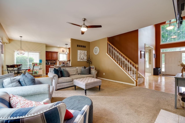 5088 Harvestdale Dr, Mason, OH 45040 - living room featuring light colored carpet, plenty of natural light, a chandelier, and stairs