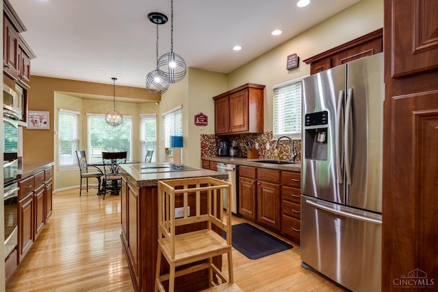 5088 Harvestdale Dr, Mason, OH 45040 - kitchen featuring appliances with stainless steel finishes, light wood-type flooring, plenty of natural light, tasteful backsplash, and recessed lighting
