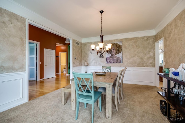 5088 Harvestdale Dr, Mason, OH 45040 - carpeted dining space featuring a chandelier, crown molding, a decorative wall, and wainscoting