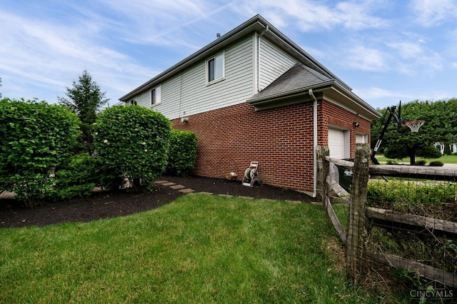5088 Harvestdale Dr, Mason, OH 45040 - view of home's exterior featuring brick siding, an attached garage, and a yard
