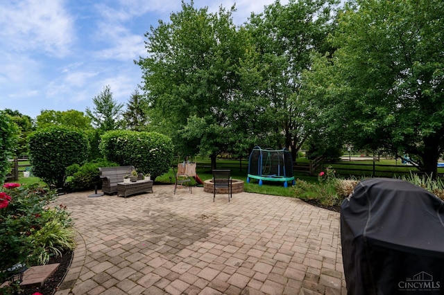 5088 Harvestdale Dr, Mason, OH 45040 - view of patio featuring grilling area, a fire pit, and view of scattered trees