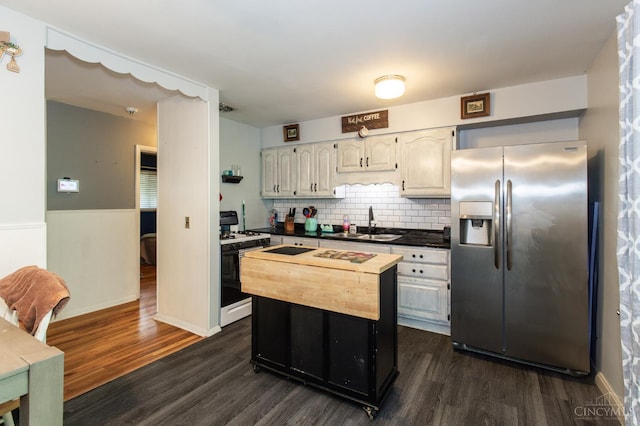 4321 Delhi, Delhi Twp, OH 45238 - kitchen with stainless steel refrigerator with ice dispenser, white range with gas cooktop, dark wood-type flooring, tasteful backsplash, and wood counters