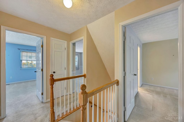 10854 Ponds Ln Unit 8, Sycamore Twp, OH 45242 - hall with an upstairs landing, light carpet, and a textured ceiling