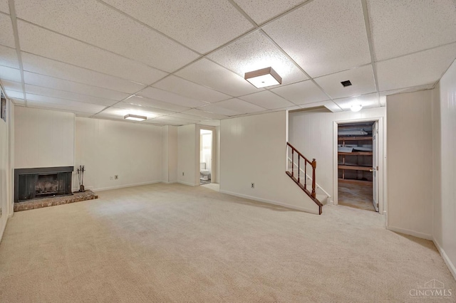 10854 Ponds Ln Unit 8, Sycamore Twp, OH 45242 - finished below grade area with a paneled ceiling, stairway, carpet flooring, and a brick fireplace