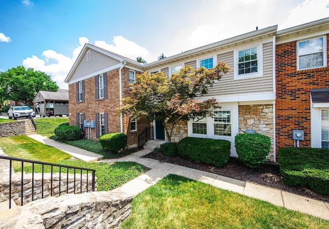 10854 Ponds Ln Unit 8, Sycamore Twp, OH 45242 - view of front of house featuring stone siding and a front lawn
