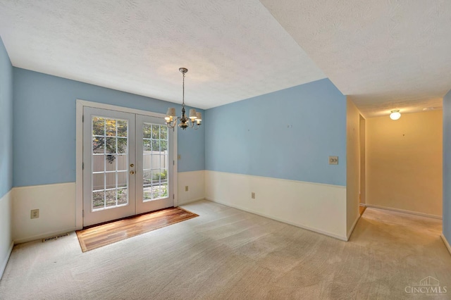 10854 Ponds Ln Unit 8, Sycamore Twp, OH 45242 - unfurnished dining area featuring french doors, carpet floors, a chandelier, and a textured ceiling