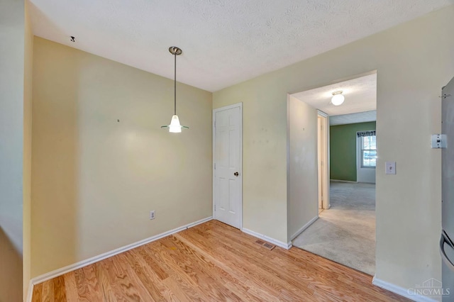 10854 Ponds Ln Unit 8, Sycamore Twp, OH 45242 - unfurnished dining area with light wood finished floors and a textured ceiling