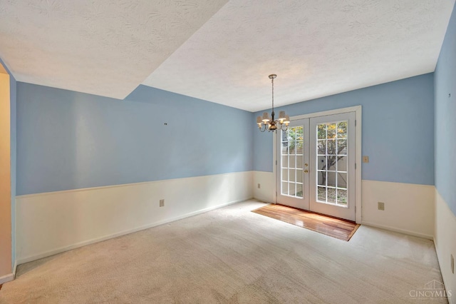 10854 Ponds Ln Unit 8, Sycamore Twp, OH 45242 - carpeted empty room with french doors, a chandelier, and a textured ceiling