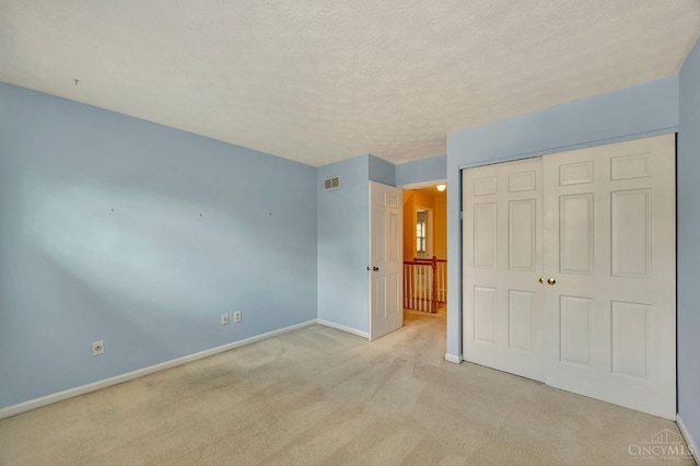 10854 Ponds Ln Unit 8, Sycamore Twp, OH 45242 - unfurnished bedroom with light colored carpet, a closet, and a textured ceiling