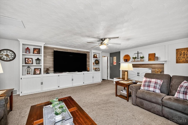 5744 Melody Ln, Milford, OH 45150 - living area featuring carpet flooring, ceiling fan, built in features, and a textured ceiling