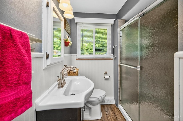 5744 Melody Ln, Milford, OH 45150 - bathroom with wood finished floors, a stall shower, vanity, and wainscoting