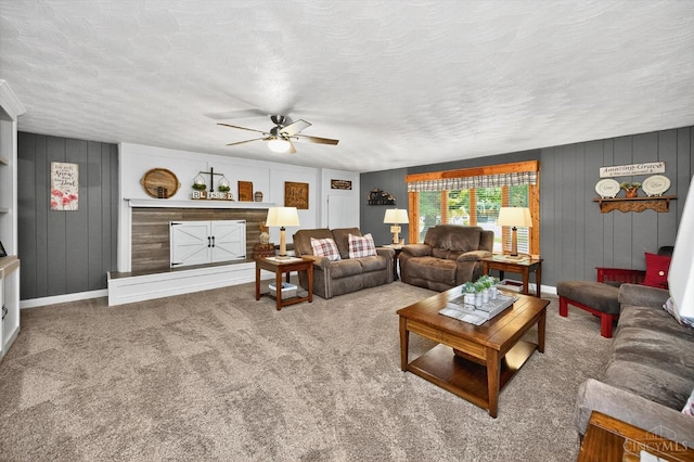 5744 Melody Ln, Milford, OH 45150 - carpeted living room with ceiling fan, a textured ceiling, and wood walls