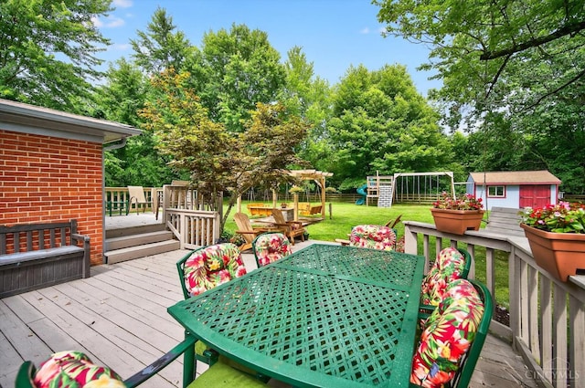 5744 Melody Ln, Milford, OH 45150 - wooden terrace with outdoor dining space, a shed, a lawn, and view of wooded area