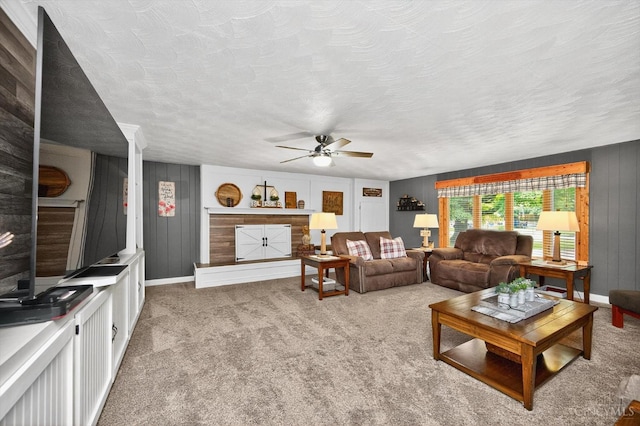 5744 Melody Ln, Milford, OH 45150 - living room with a ceiling fan, carpet floors, wooden walls, and a textured ceiling