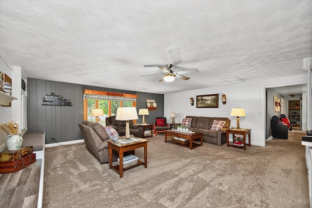 5744 Melody Ln, Milford, OH 45150 - living room with a ceiling fan, a textured ceiling, carpet floors, and wood walls