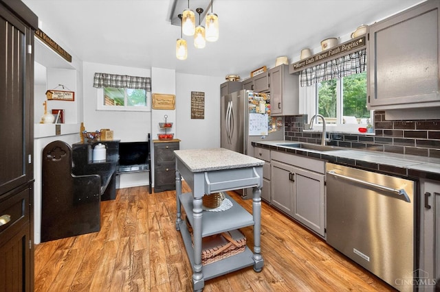 5744 Melody Ln, Milford, OH 45150 - kitchen featuring stainless steel appliances, tile counters, light wood-style flooring, and tasteful backsplash