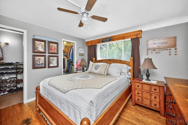 5744 Melody Ln, Milford, OH 45150 - bedroom with a spacious closet, wood finished floors, and a ceiling fan