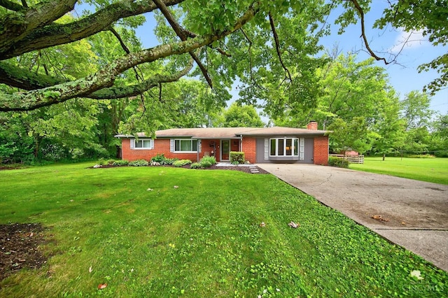 5744 Melody Ln, Milford, OH 45150 - ranch-style house with a chimney, driveway, brick siding, and a front yard