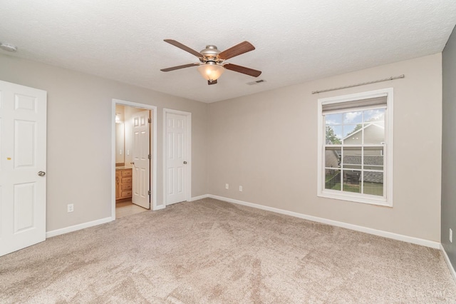2033 Jackson Ln, Middletown, OH 45044 - unfurnished bedroom featuring light carpet, a textured ceiling, ensuite bath, and a ceiling fan