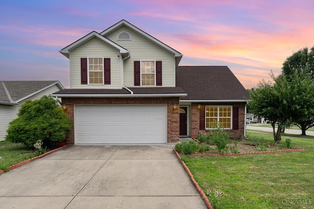 2033 Jackson Ln, Middletown, OH 45044 - traditional home featuring brick siding, driveway, an attached garage, and a lawn