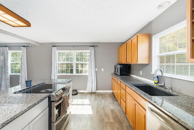 11818 Cloverlick Rd, Bethel, OH 45106 - kitchen with appliances with stainless steel finishes, light wood finished floors, and light stone countertops