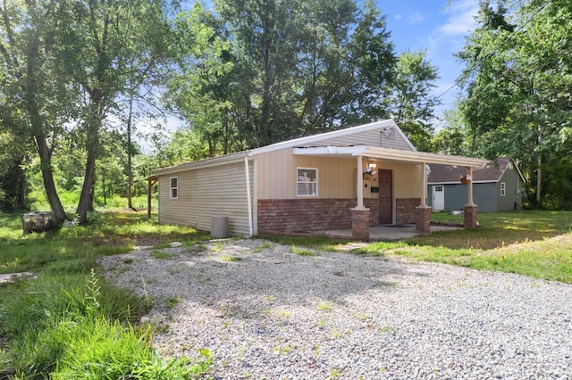 340 N E St, Bethel, OH 45106 - view of front facade featuring brick siding and covered porch