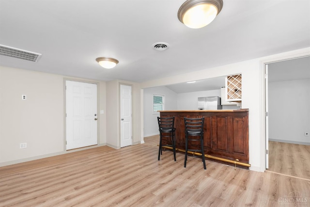 340 N E St, Bethel, OH 45106 - indoor dry bar featuring stainless steel refrigerator and light wood-style flooring