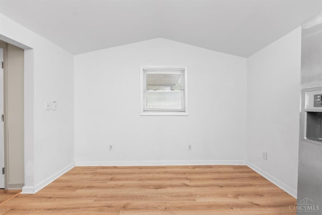 340 N E St, Bethel, OH 45106 - unfurnished room featuring light wood-style flooring and lofted ceiling