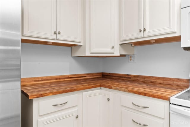 340 N E St, Bethel, OH 45106 - kitchen featuring wooden counters, stainless steel fridge, and white cabinets